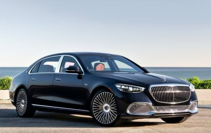 Black Mercedes-Maybach S680 — front three-quarter view by the ocean