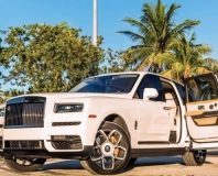 White Rolls-Royce Cullinan Black Badge with its rear door open