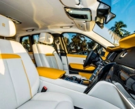 White leather front seats and yellow trim in the Rolls-Royce Cullinan Black Badge