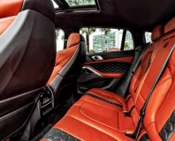 Graphite BMW X6 M Competition — orange leather rear seats