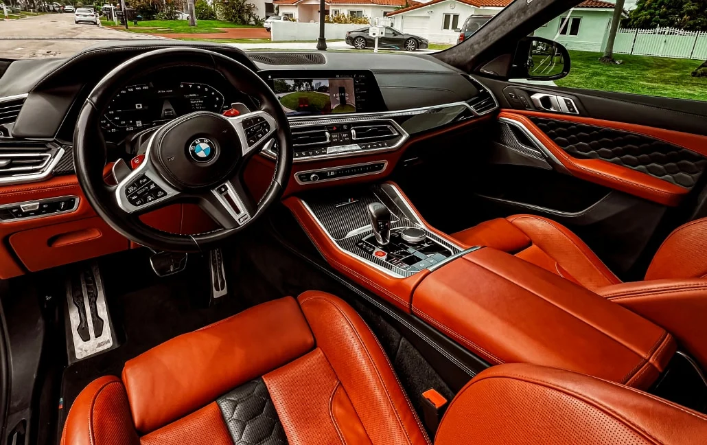 Graphite BMW X6 M Competition — orange leather front cabin and dashboard