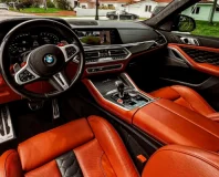 Graphite BMW X6 M Competition — orange leather front cabin and dashboard