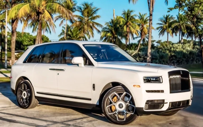 White Rolls-Royce Cullinan Black Badge parked beneath palm trees