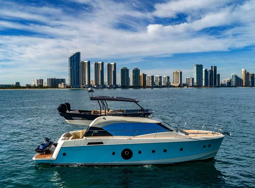 Monte Carlo 65 yacht with the city skyline behind it
