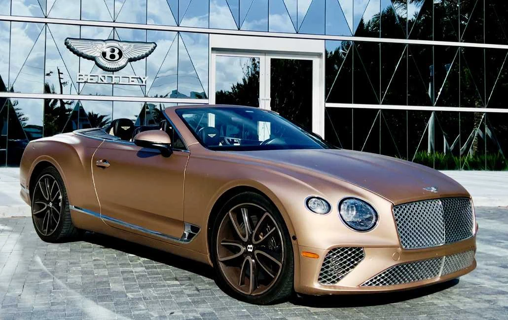 Gold Bentley GTC Mulliner inside a showroom