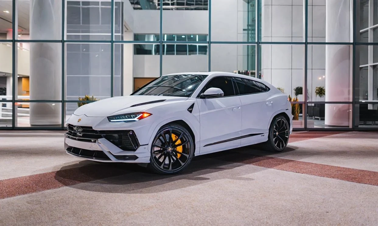 White Lamborghini Urus outside a building