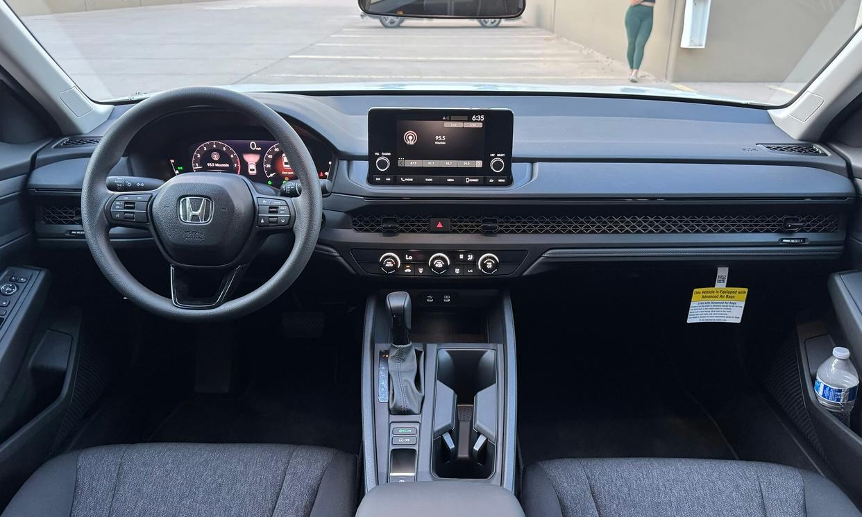 Dashboard and driving controls of the white Honda Accord LX