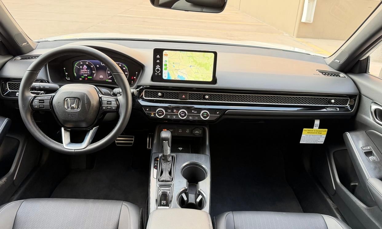 Dashboard and driving controls of the white Honda Civic Hybrid Sport Touring