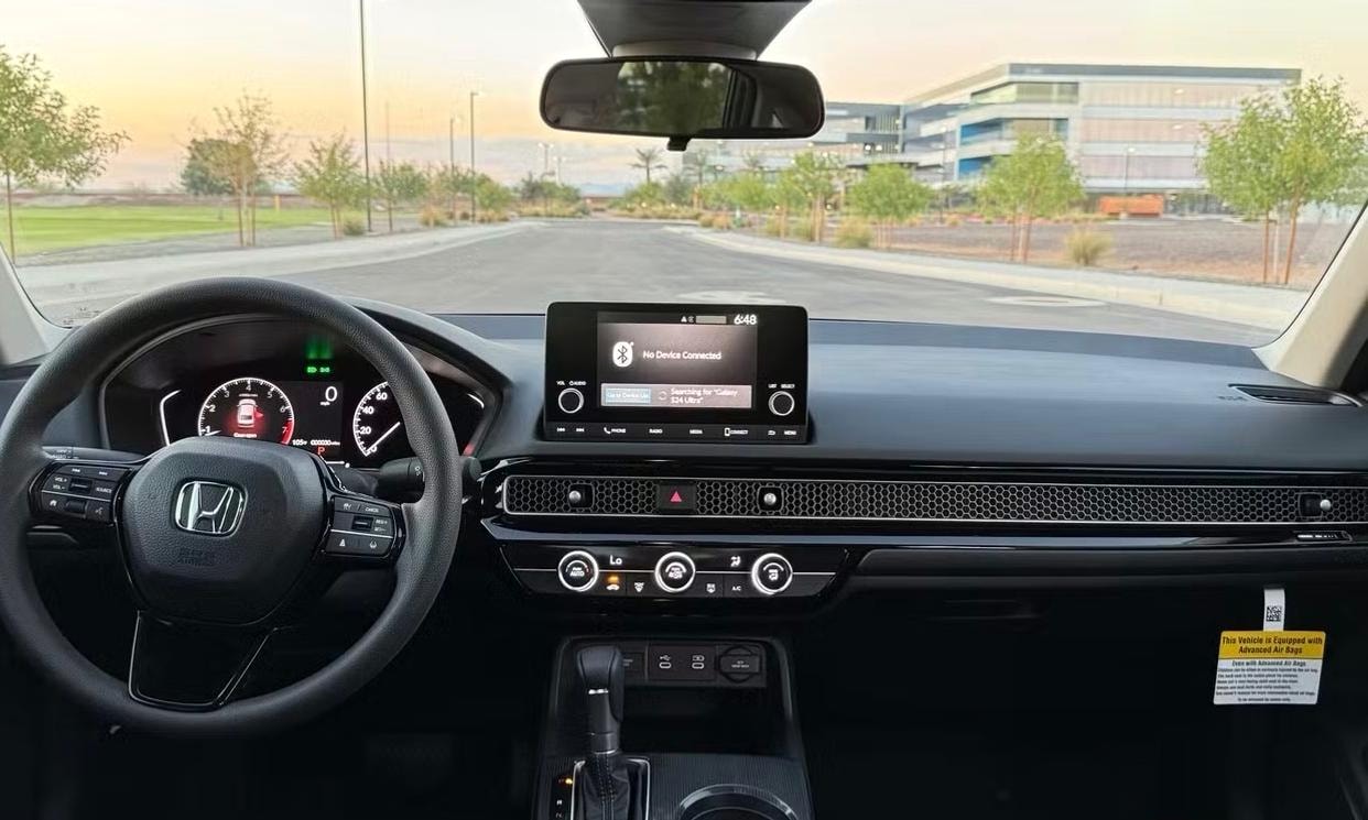 Dashboard and driving controls of the silver Honda Civic LX