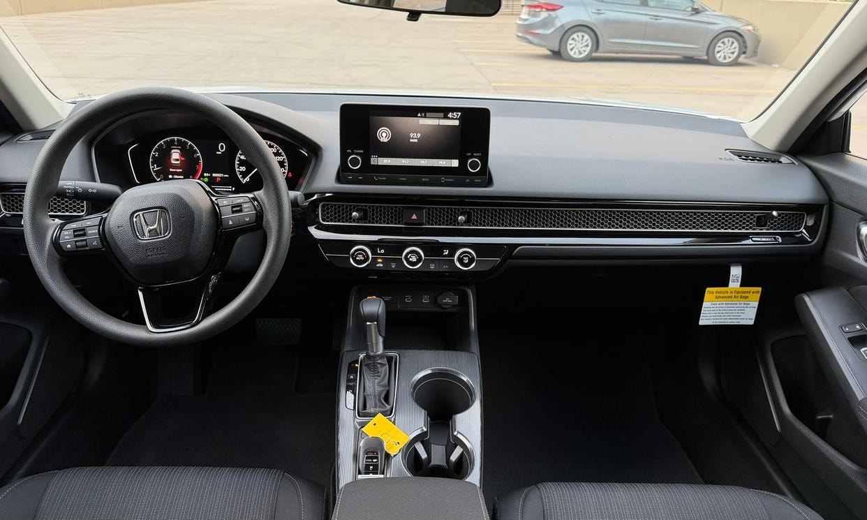 Dashboard and driving controls of the white Honda Civic LX