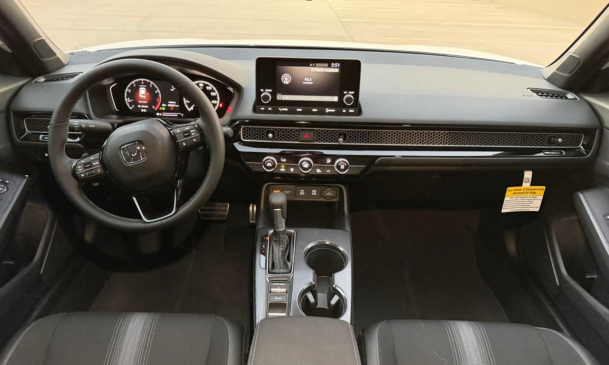 Dashboard and driving controls of the white Honda Civic Sport
