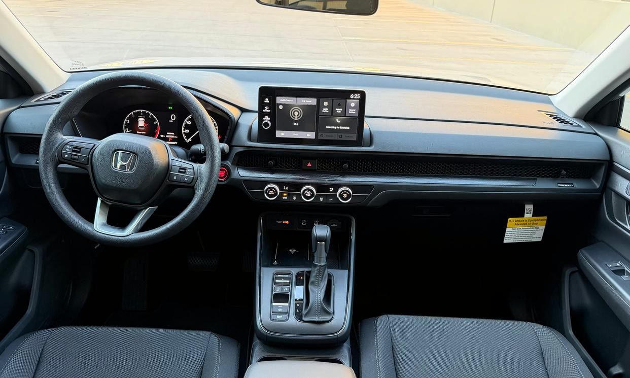 Dashboard and driving controls of the silver Honda CR-V LX