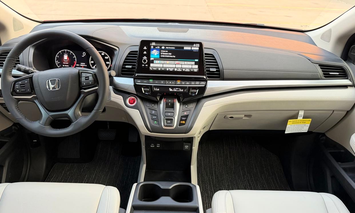 Dashboard and driving controls of the red Honda Odyssey EX-L