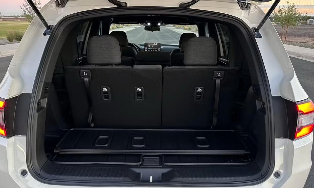 Open cargo area of the white Honda Pilot Sport