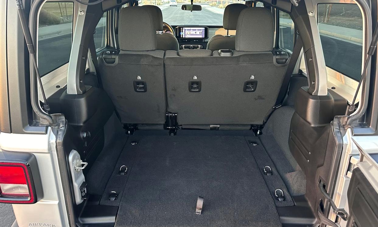 Open cargo area of the silver Jeep Wrangler Sport