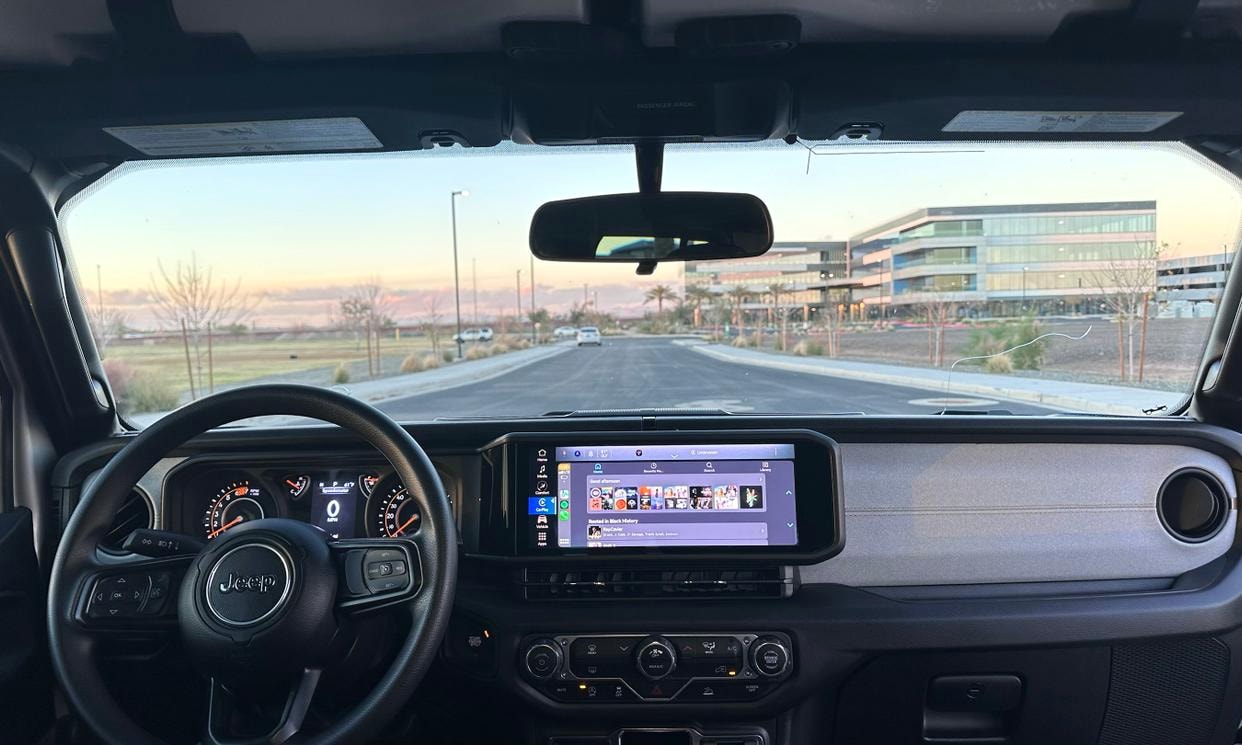 Dashboard and driving controls of the silver Jeep Wrangler Sport