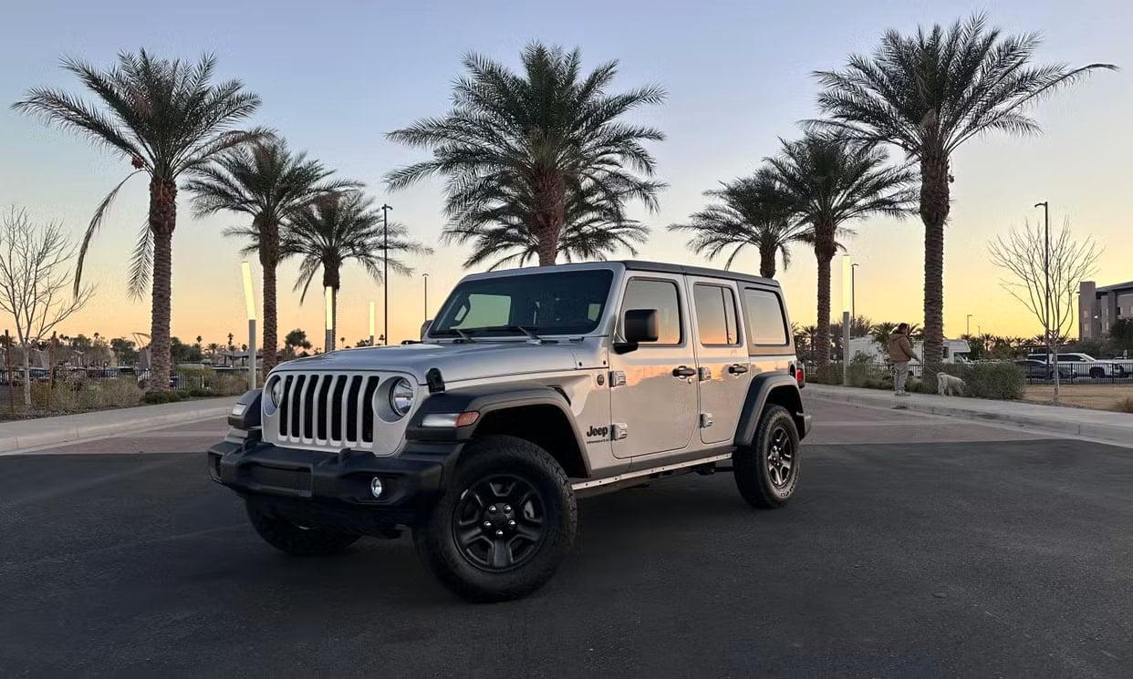 Front three-quarter view of the silver Jeep Wrangler Sport