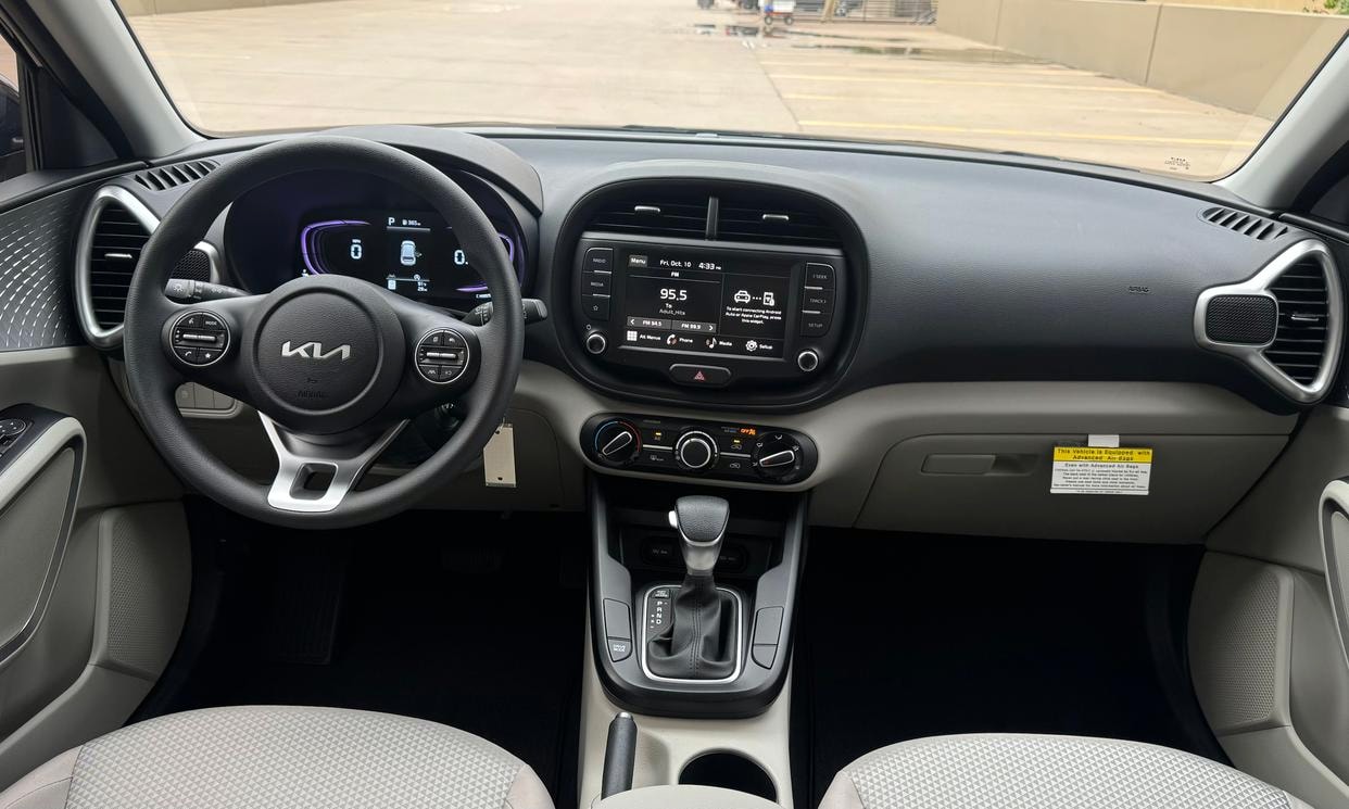 Dashboard and driving controls of the black Kia Soul LX