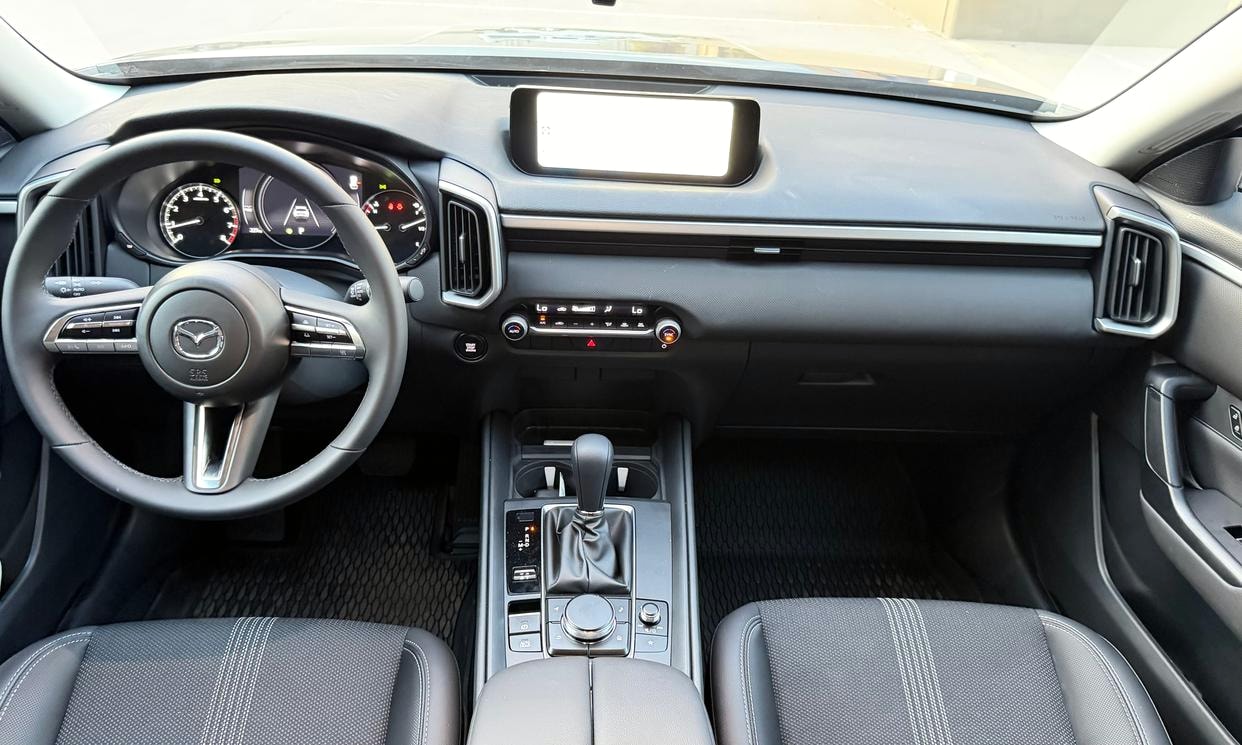 Dashboard and driving controls of the blue Mazda CX-50 2.5 S Select