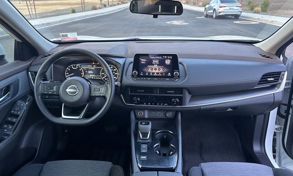 Dashboard and driving controls of the white Nissan Rogue SV