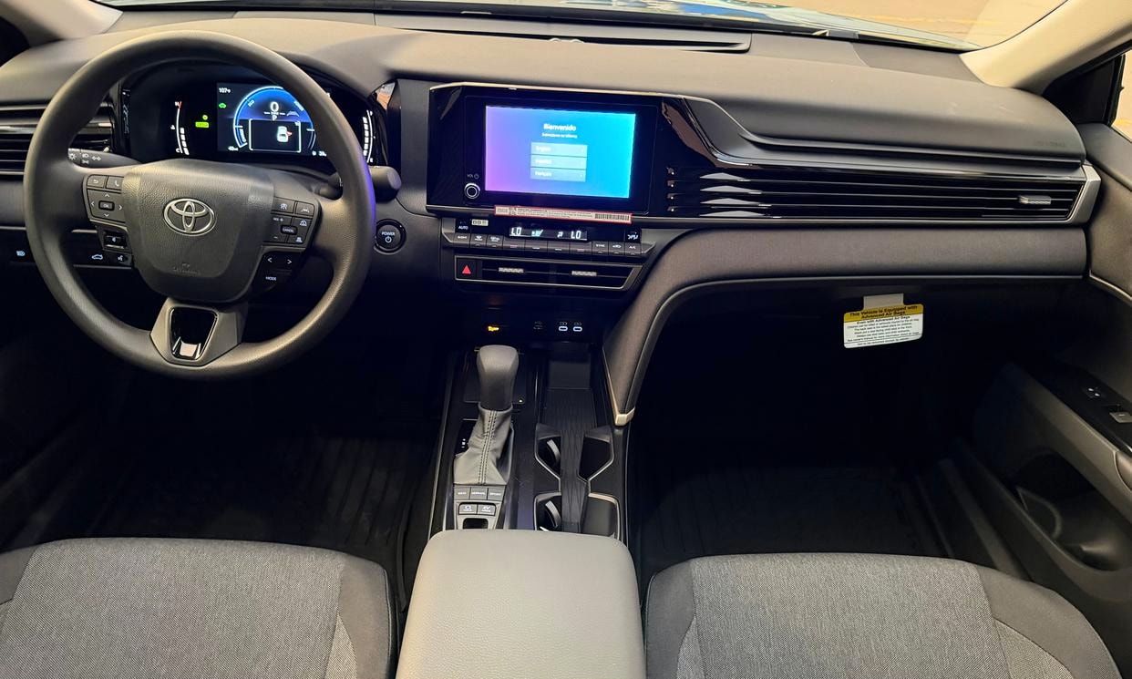 Dashboard and driving controls of the blue Toyota Camry Hybrid LE