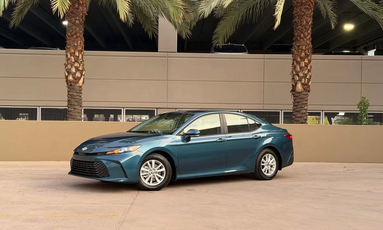 Front three-quarter view of the blue Toyota Camry Hybrid LE