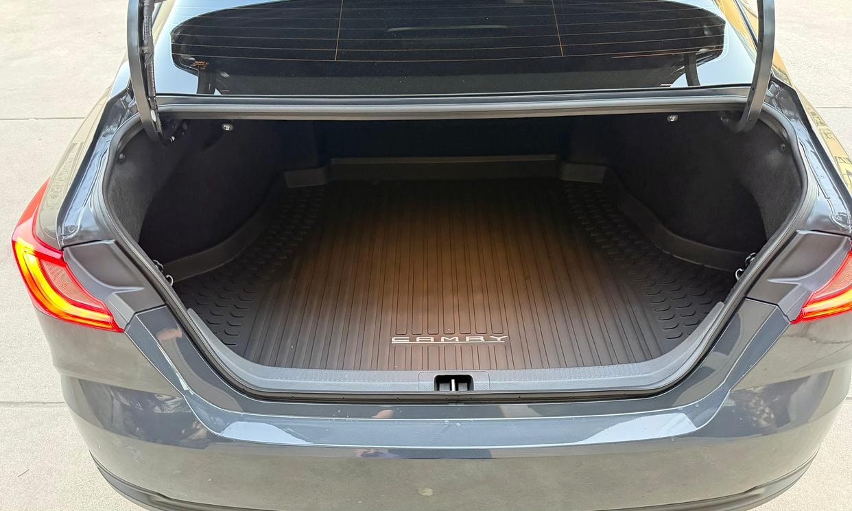 Open cargo area of the gray Toyota Camry Hybrid LE