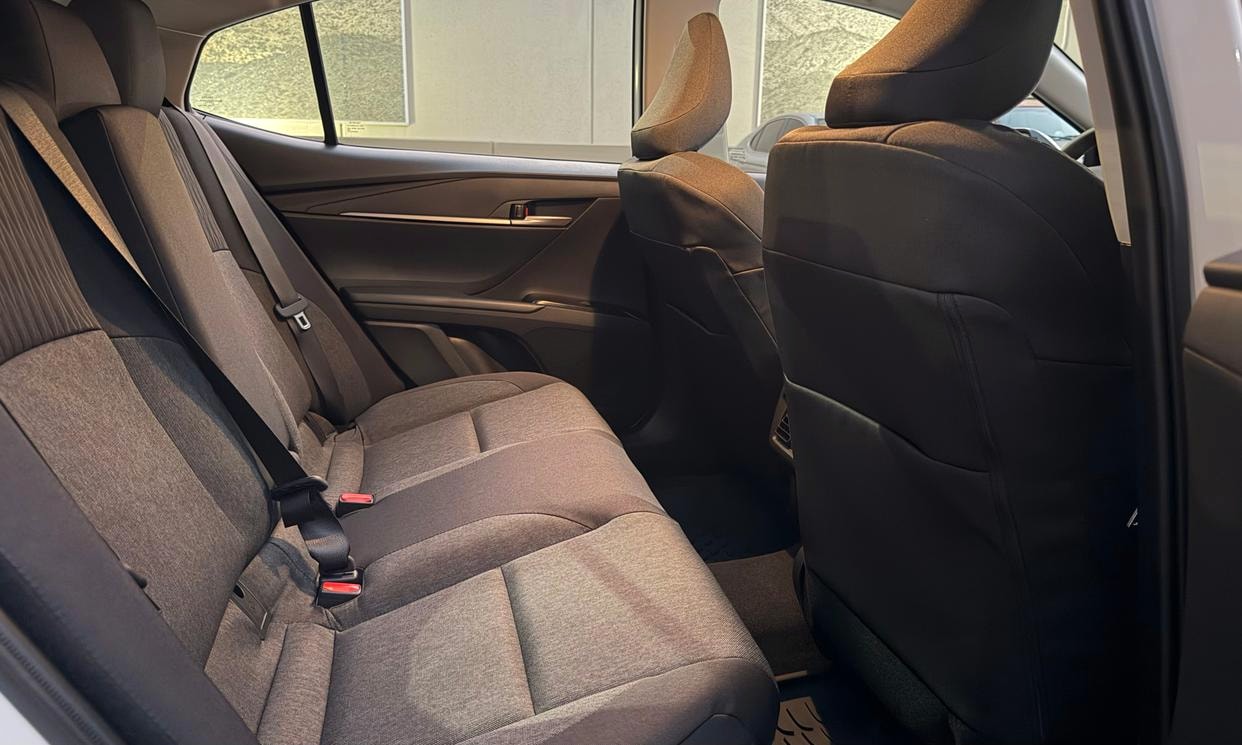 Passenger seating in the white Toyota Camry Hybrid LE