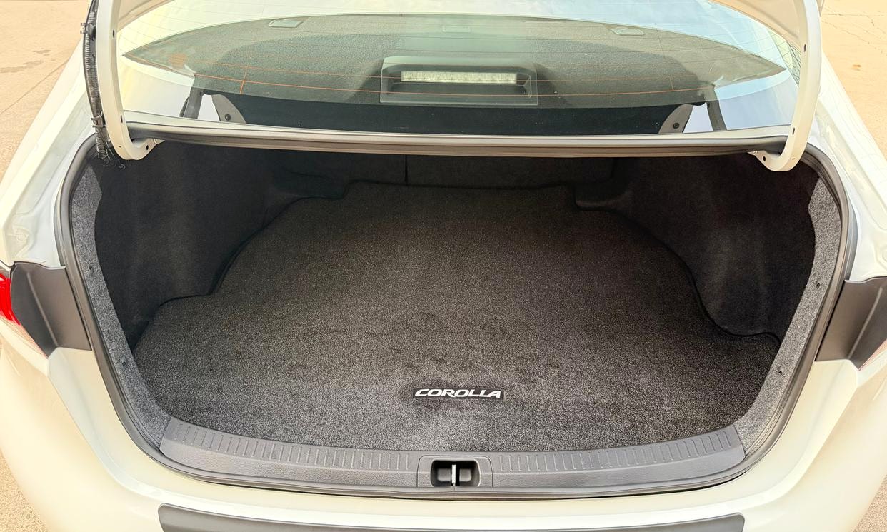 Open cargo area of the white Toyota Corolla LE
