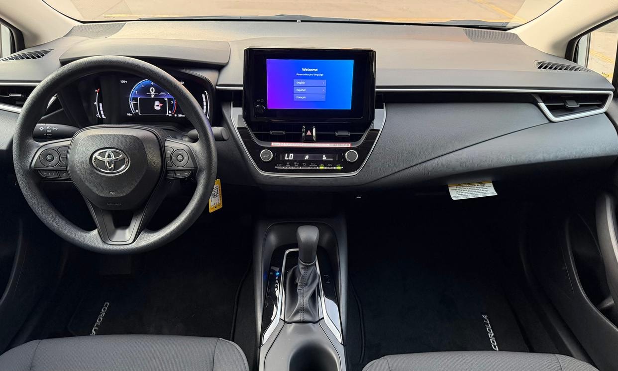 Dashboard and driving controls of the white Toyota Corolla LE