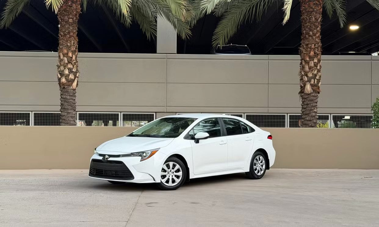 Front three-quarter view of the white Toyota Corolla LE