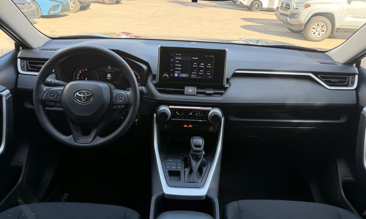 Dashboard and driving controls of the silver Toyota RAV4 LE