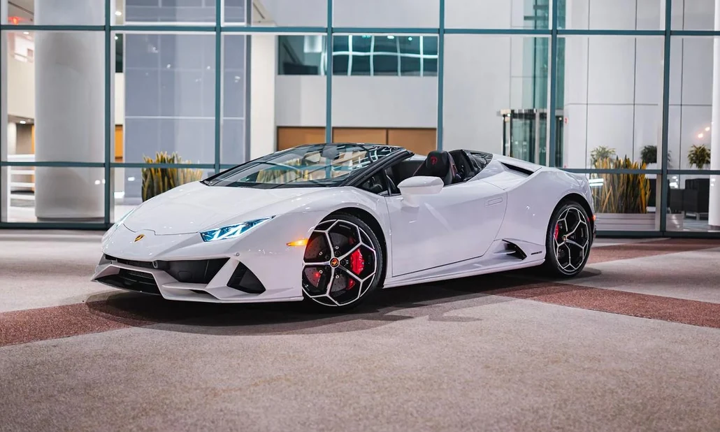 White Lamborghini Huracan EVO Spyder Rental in Miami, front three-quarter view with roof open