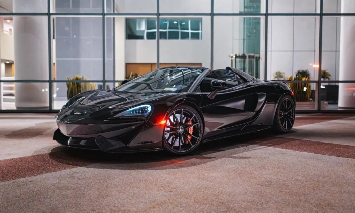 McLaren 570S Spider — Black, front three-quarter view with doors closed