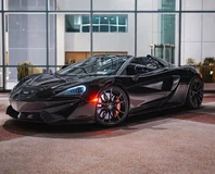 Black McLaren 570S Spider Rental in Miami, front three-quarter view with doors closed