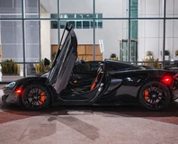 McLaren 570S Spider — Black, side profile with roof open