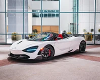 White McLaren 720S Spider Rental in Miami, front three-quarter view with roof open