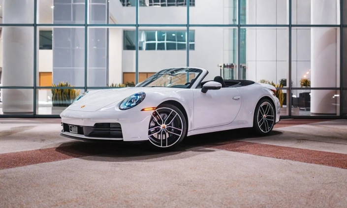 Porsche 911 Carrera Cabriolet — White, front three-quarter view with roof open