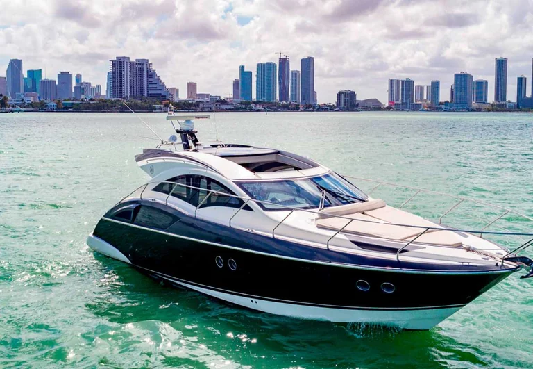 43-foot Marquis yacht with the city skyline behind it